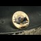 The RAF Battle of Britain Spitfire Coin on metal surface and sand on forefront