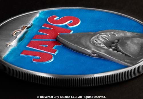 Close-up of Jaws commemorative on black surface