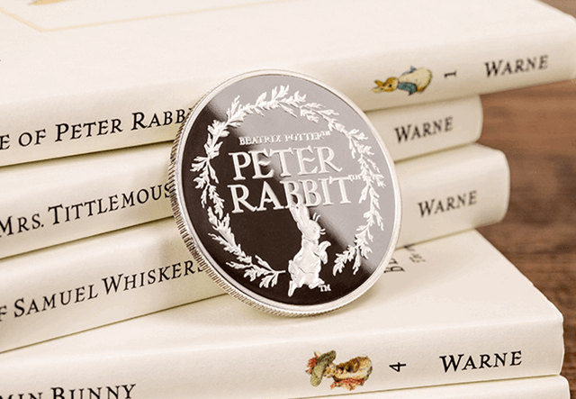 Peter Rabbit - My First Medal Obverse leaning against book spines