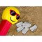 Silver Pez on Sand Background with Smiley Face Dispenser