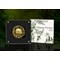 Gold Edition Filigree Panda Coin in open box beside packaging on a jungle background