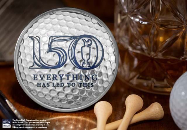 The 150th Open Silver 5oz Domed Commemorative on table with tees and golf ball